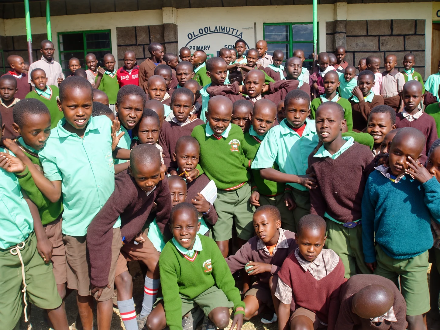 A group of students gathered outside their school.